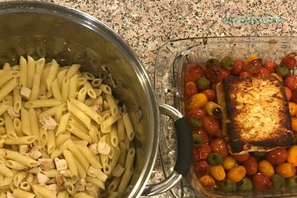 Cooked chicken with pasta on the left, baked feta atop tomatoes and olives on the right