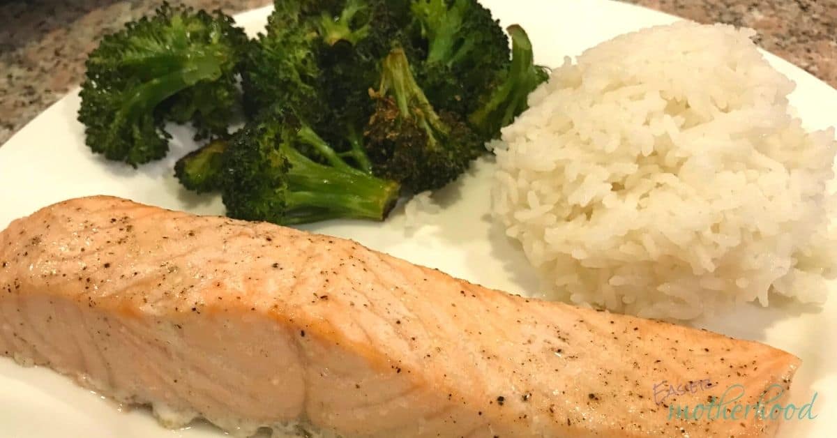 Baked Salmon on a white plate with roasted broccoli and white rice