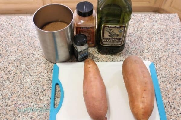 Ingredients for roasted sweet potato slices on kitchen counter