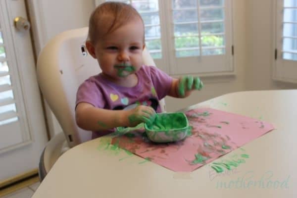 Young girl after playing with edible yogurt finger paint, pre-cleanup