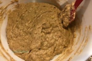 Combining the wet and dry ingredients to form the banana bread batter