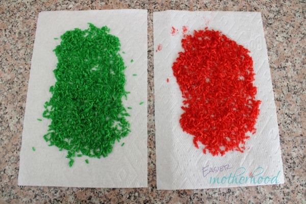 Green and Red dyed rice drying on paper towels before going into the christmas sensory shaker bottle.