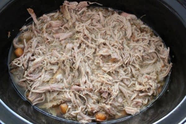 Pulled pork in the crockpot shredded and ready to serve.