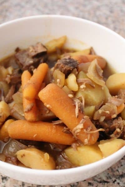 White bowl filled with crock pot beef stew