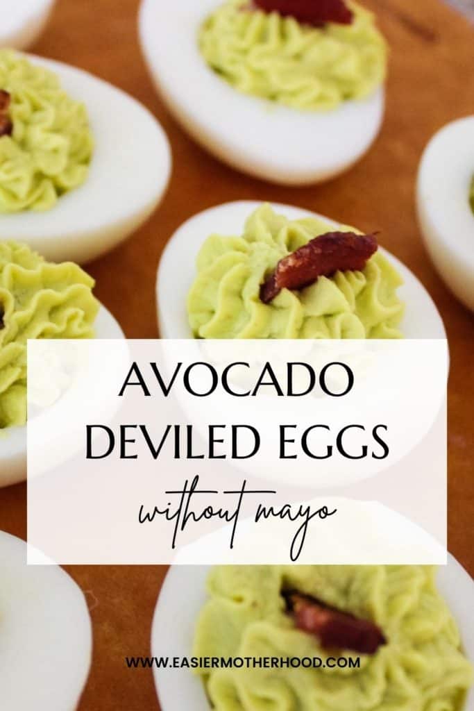 Pinterest image of finished recipe on a serving board. Text overlay reads "avocado deviled eggs without mayo".